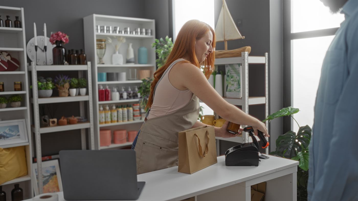 Store associate scanning items at a modern retail checkout counter